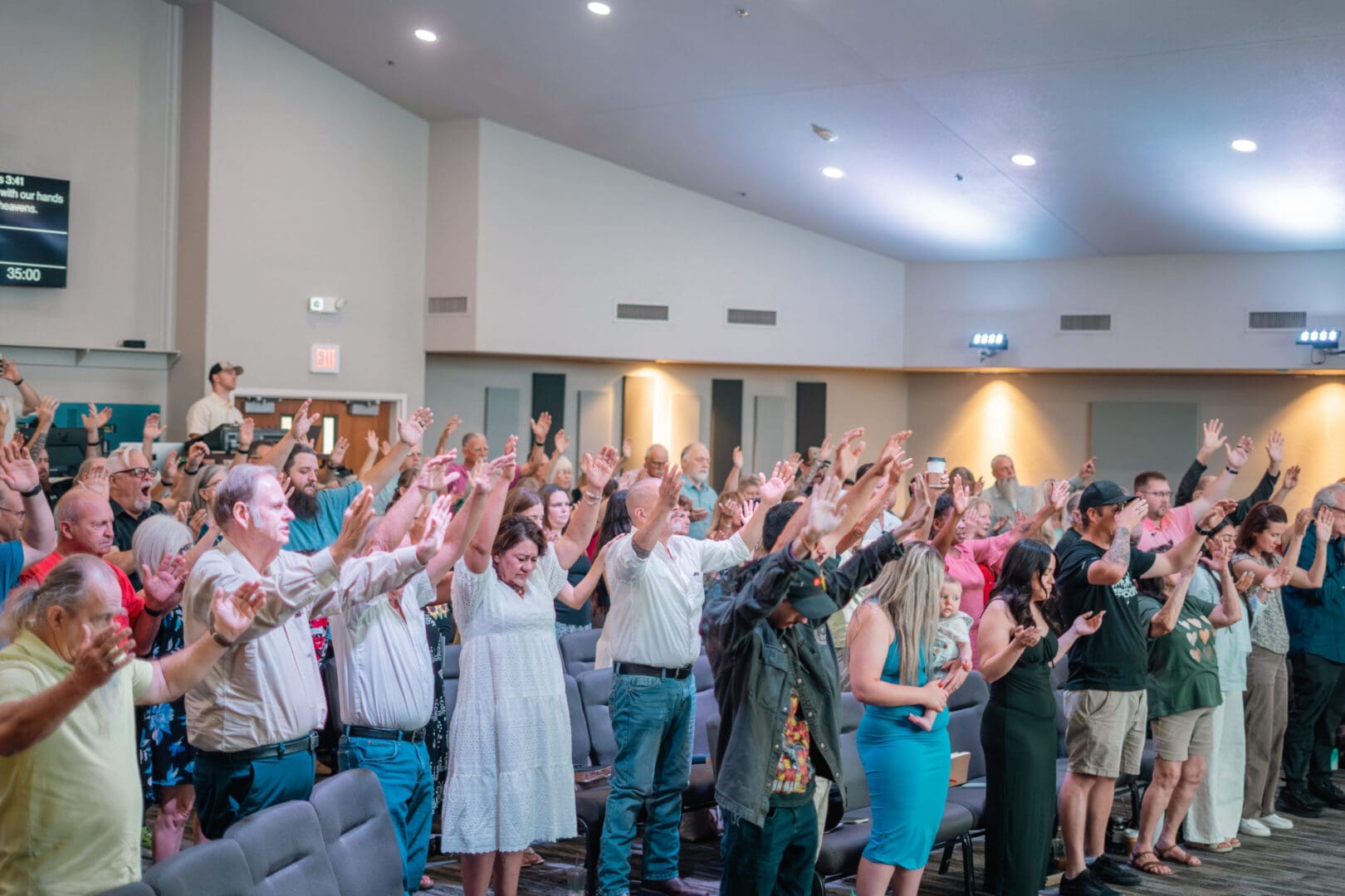 Congregation raising hands during worship service